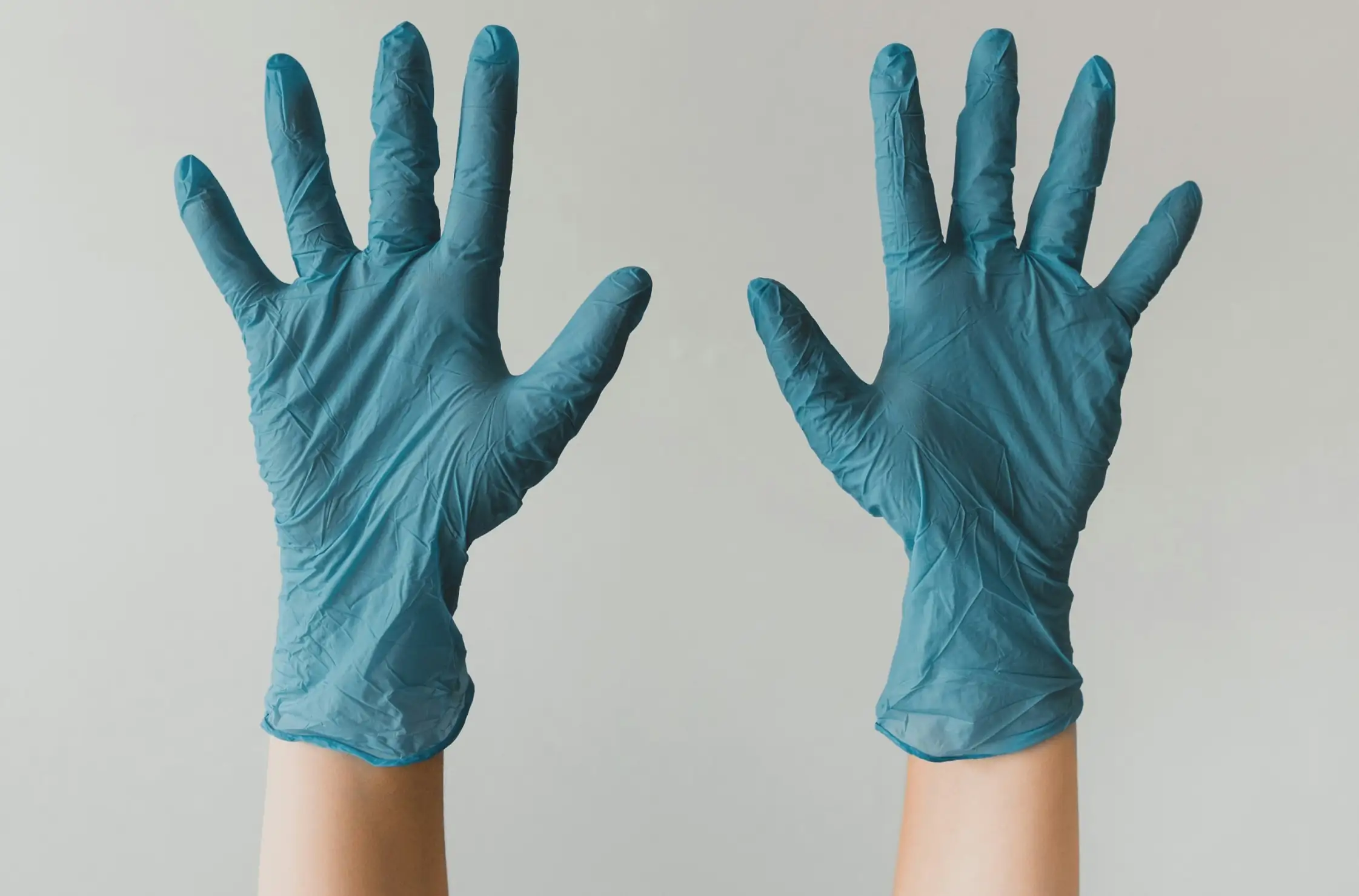 image of hands in cleaning gloves.